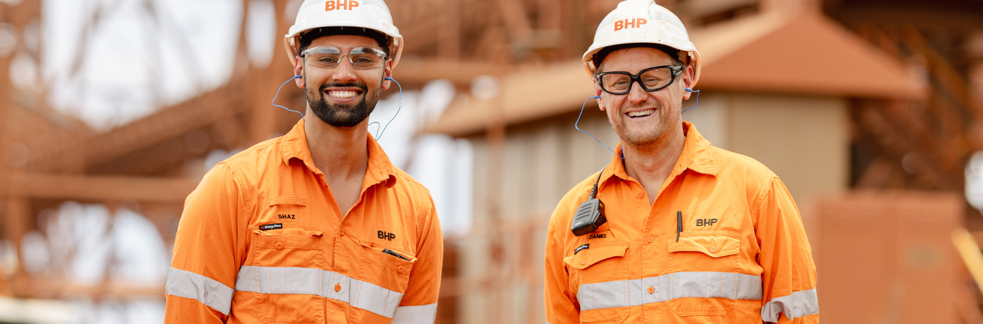 two people looking into the camera at a mine site